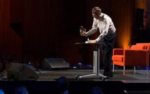 Bill Gates releasing mosquitoes during a conference presentation